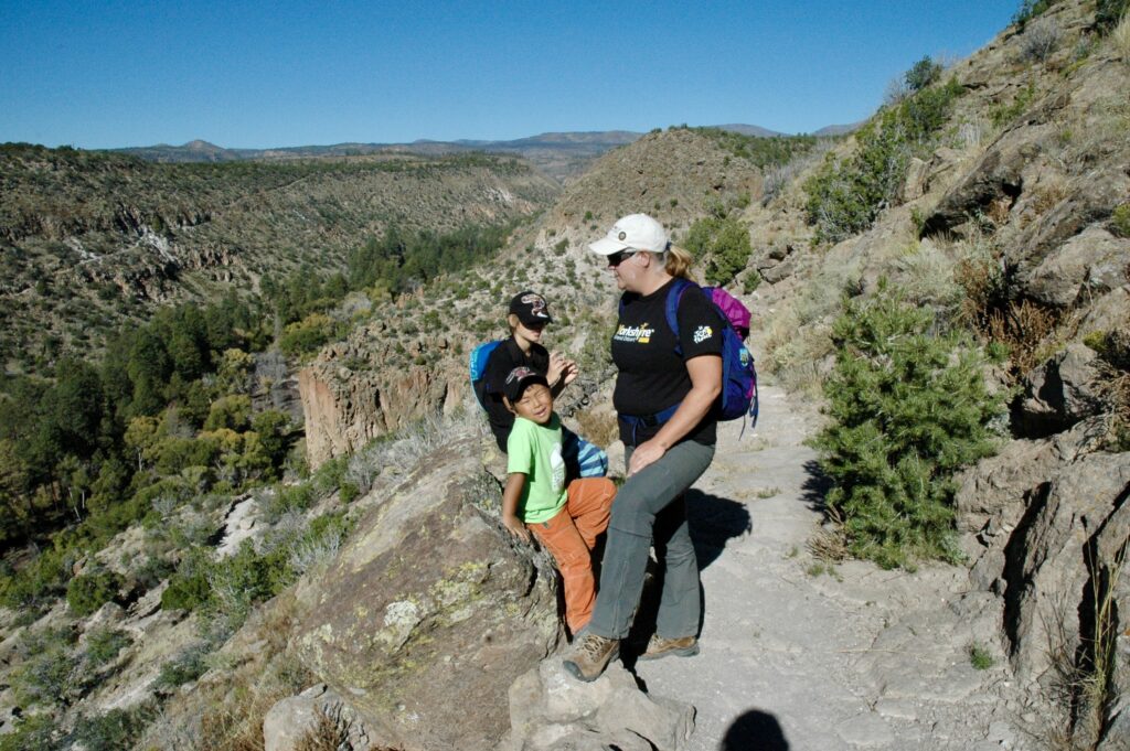Hiking along the rim of the mesa on the Frey Trail in Bandelier National Monument.