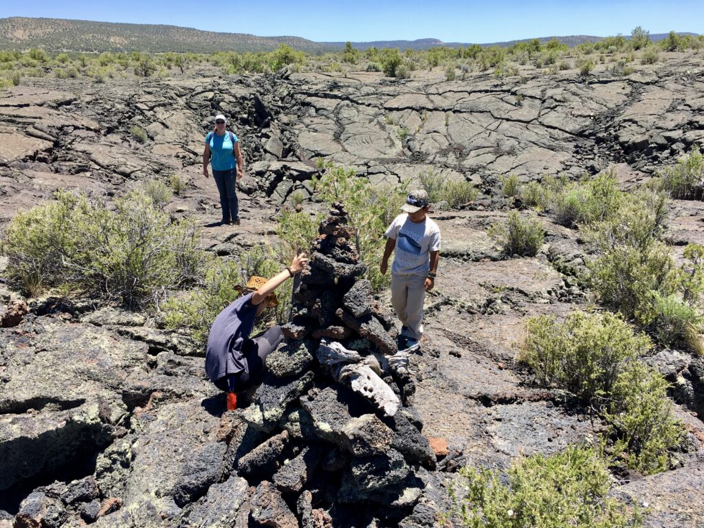 Adding to one of the cairns on the Lava Falls Trail in El Maipais National Monument, New Mexico.