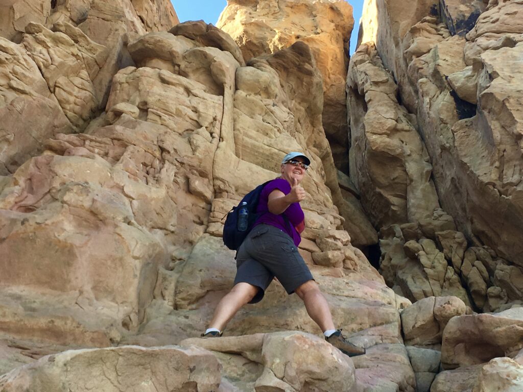 Looking cool as she traverses across a ledge at the sandstone cliffs of El Maipais National Monument, New Mexico.